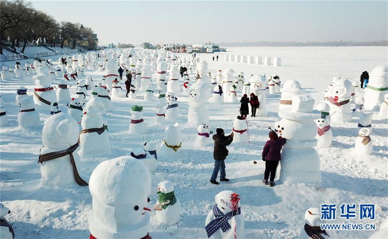 1月2日，市民、游客在雪人群中游玩觀賞（無人機拍攝）。2019個各式各樣的雪人，近日在冰城哈爾濱市的松花江畔亮相，引來眾多市民游客游玩觀賞。新華社記者 王建威 攝
